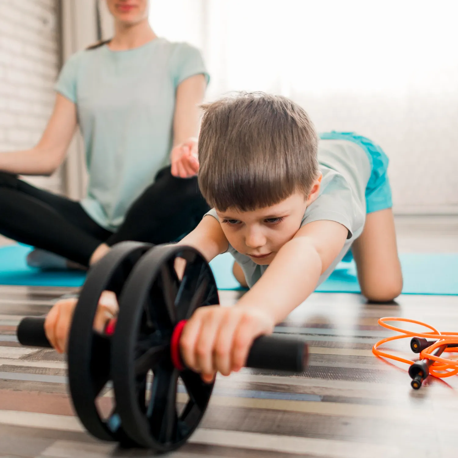 Cute little boy training with mother at home<br />